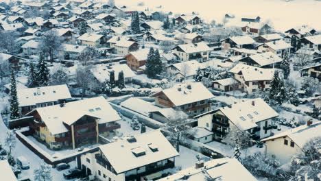 snowy houses in german town of garmisch-partenkirchen, drone shot