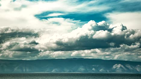 time lapse cloudscape. white clouds float above the smooth lake.