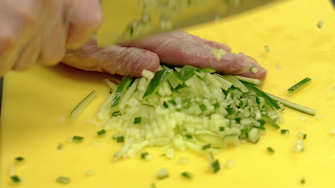 Cook very quickly cuts fresh cucumber