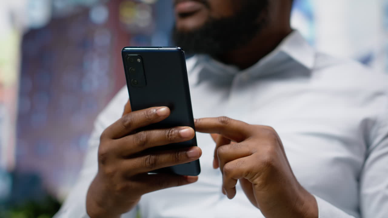 Black man looking for directions on smartphone map app during a stroll