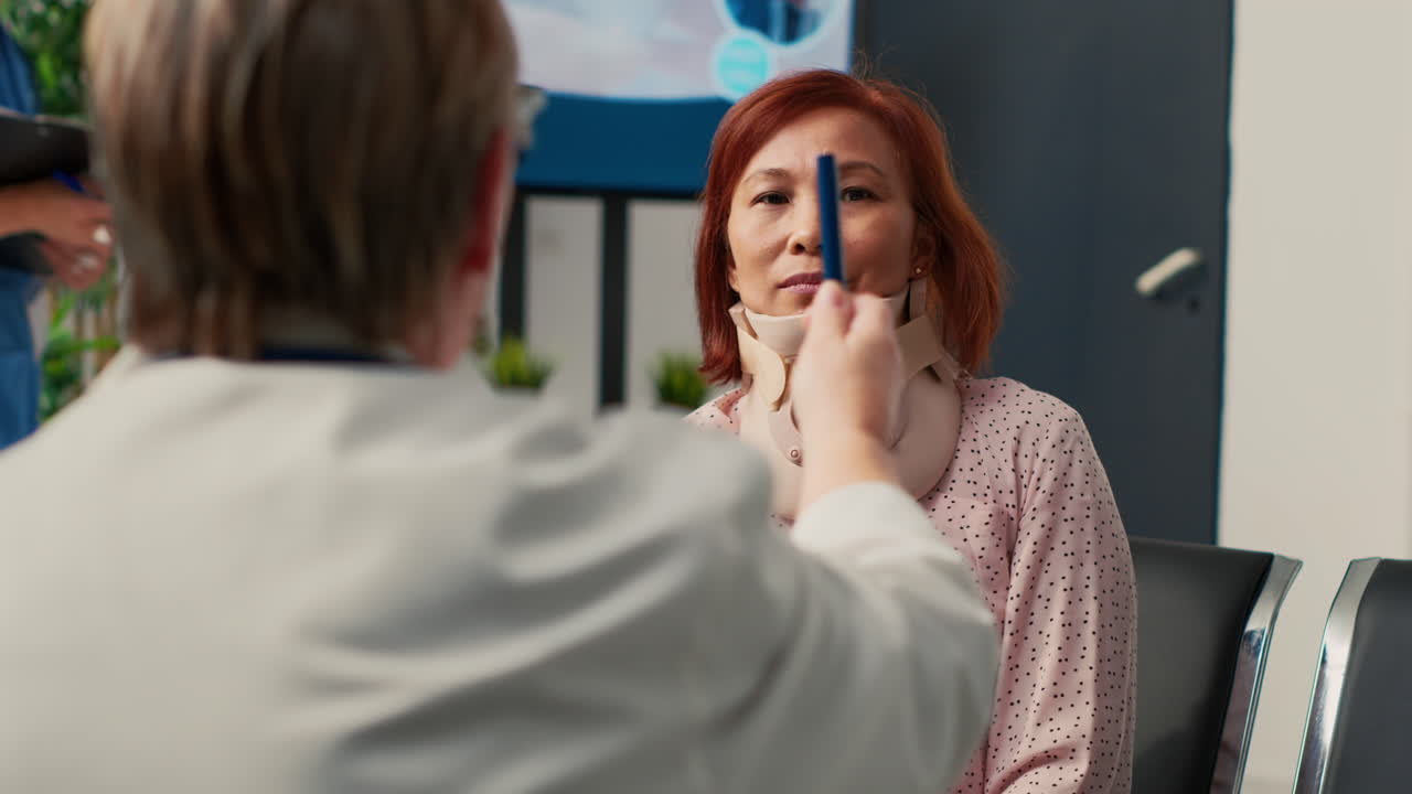 Woman with neck brace consulting with doctor