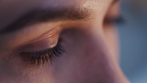 concentrated woman's eyes while working on laptop close-up