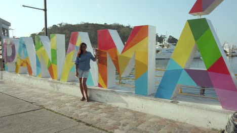 sexy model standing by the panama sign in panama city, panama