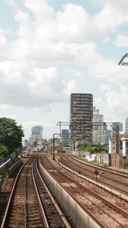 canary wharf in london, pov shot from the moving docklands light railway in vertical