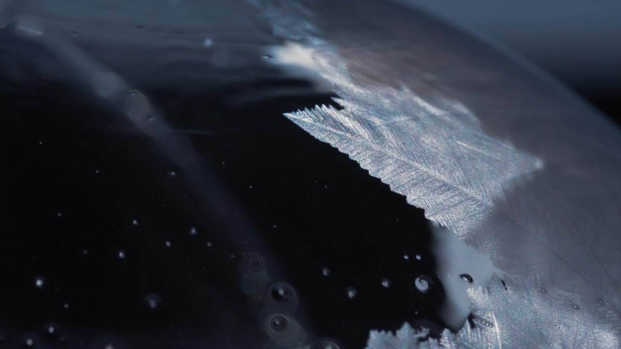 Abstract freezing ice pattern covering the soap bubble in winter