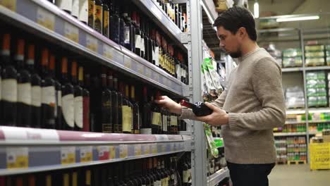 man shopping for wine in a grocery store