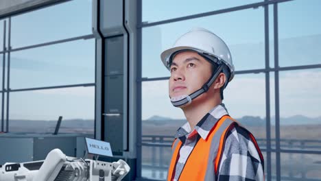 engineer observing industrial robot