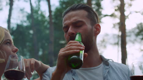 Positive-man-and-women-having-fun-on-bbq-party.-Relaxed-guys-talking-outside