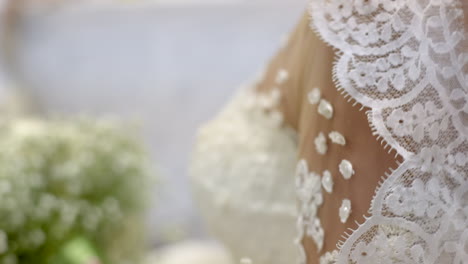 detail of a bridal dress while bride getting ready at beauty salon on wedding day