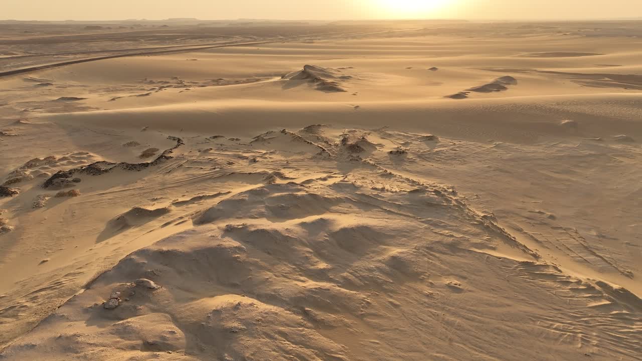 Sand Dunes and a Road Cutting Through the Desert