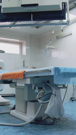 empty operating room. surgical bed in the middle of operating room with modern medical equipment in the hospital. medical devices. vertical video