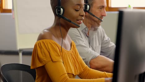 Business-executives-working-with-headset-on-desk-4k