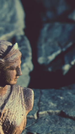 close-up of a weathered classical statue of a woman