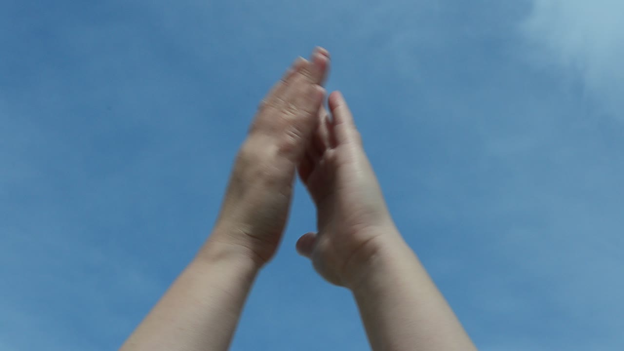 Hands against the sky. Various emotions