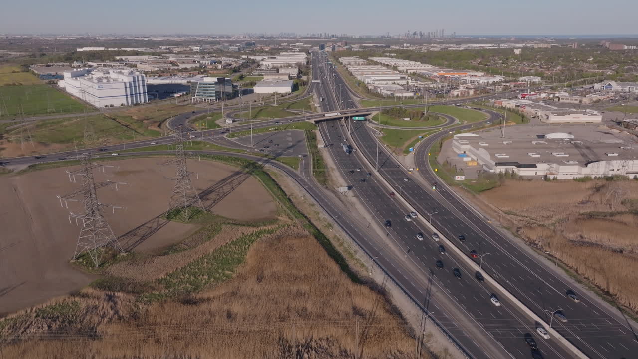 The highway 401 in mississauga, showing a busy interchange and power lines, aerial view