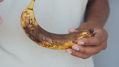 person holding a very ripe banana