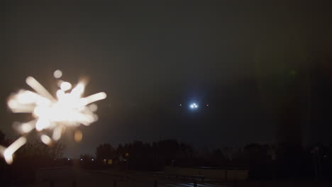 airplane landing at night with sparkler