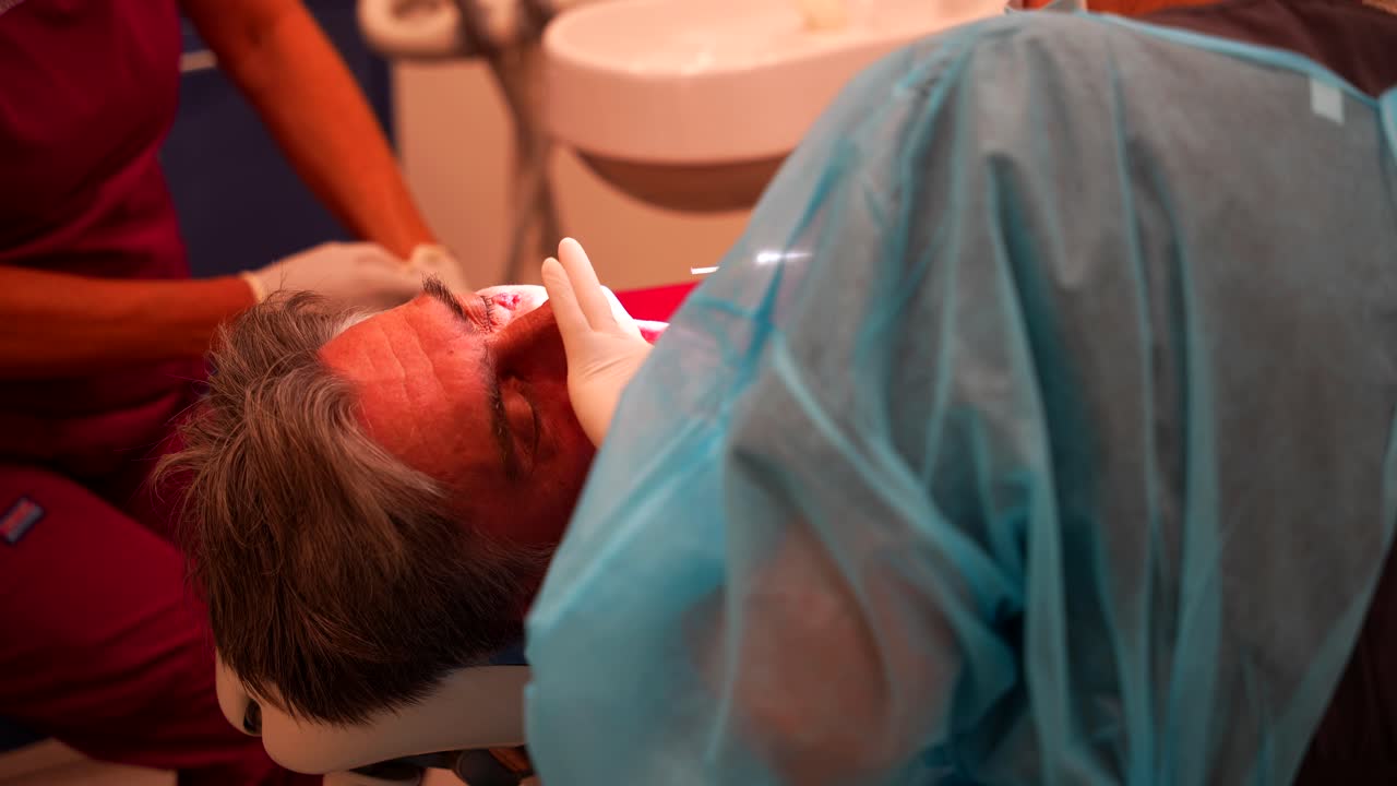 A male patient undergoing a dental procedure