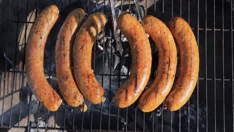 grilled sausages on a charcoal grill