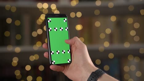 closeup view of smartphone with tracking points on screen in man hands against bokeh background
