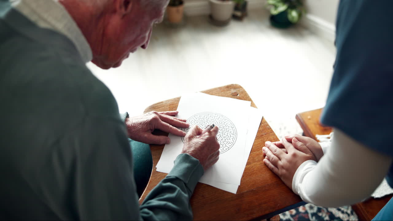 Elderly Man Solving Maze with Caregiver's Assistance