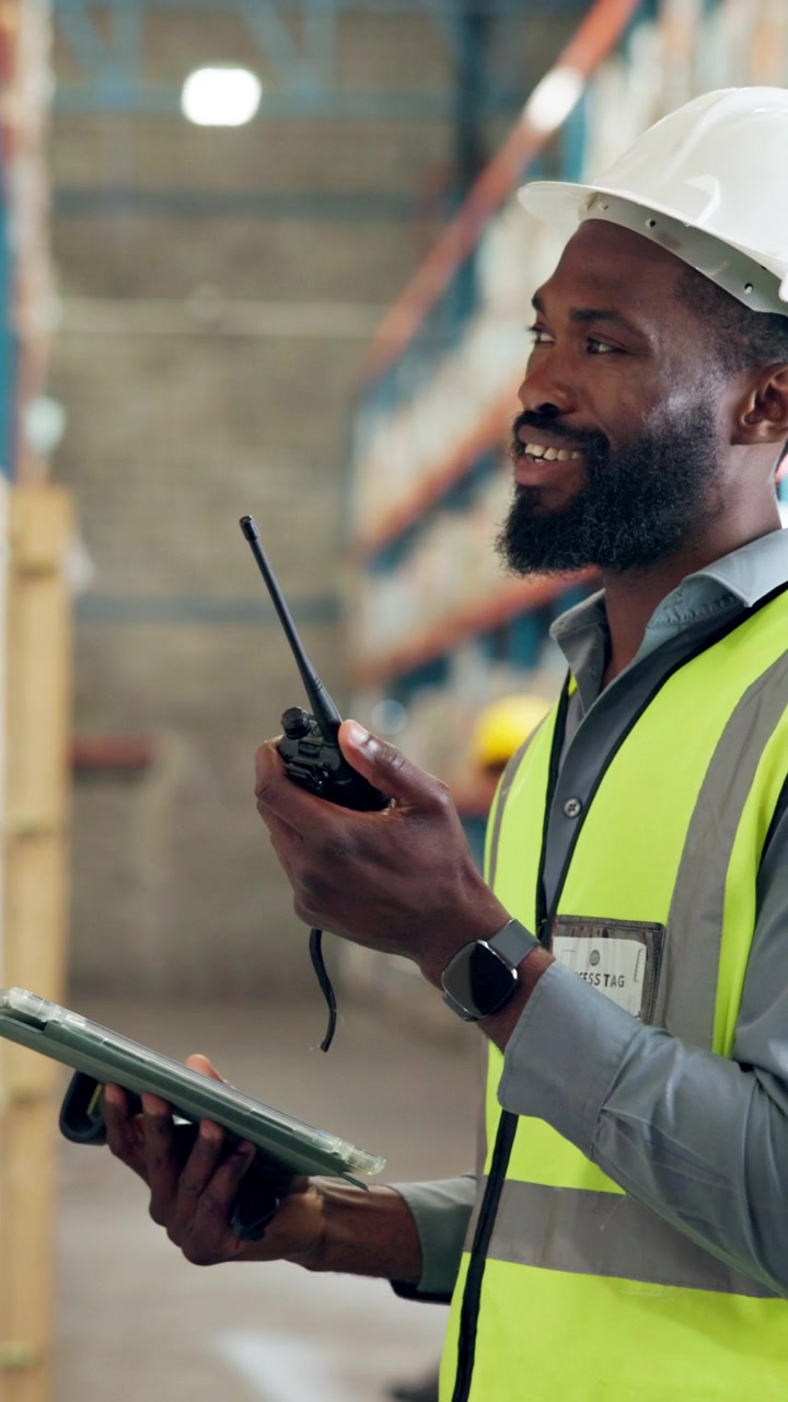Warehouse Manager Communicating via Two-Way Radio in Distribution Center