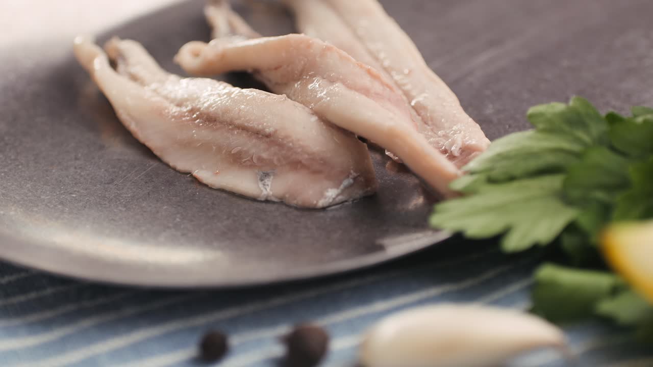 Fresh Sea sardines and Anchovy Fish and Mullus On Display On Ice On Market Store Shop. Seafood Fish Background, close up stand of small salty white fish.