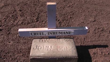 a lone unmarked grave has been placed in a freshly plowed field