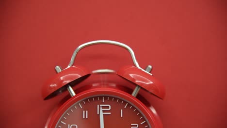 red alarm clock on red background