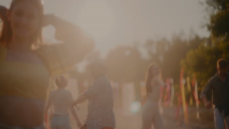 carefree woman running and jumping against friends