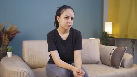 young woman looking at camera with trouble.