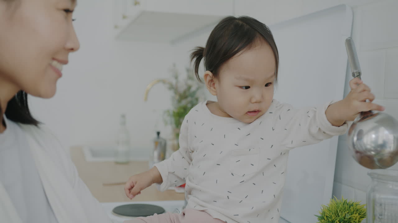 Mother and Toddler Playing in the Kitchen
