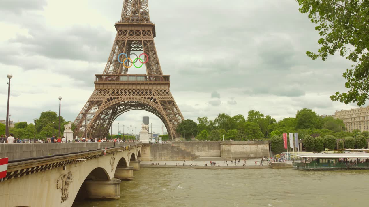 Eiffel Tower Adorned with Olympic Rings over Seine River in Paris