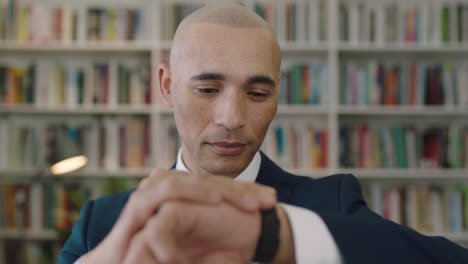 portrait ofmature hispanic businessman looking at watch waiting in office library feeling optimistic