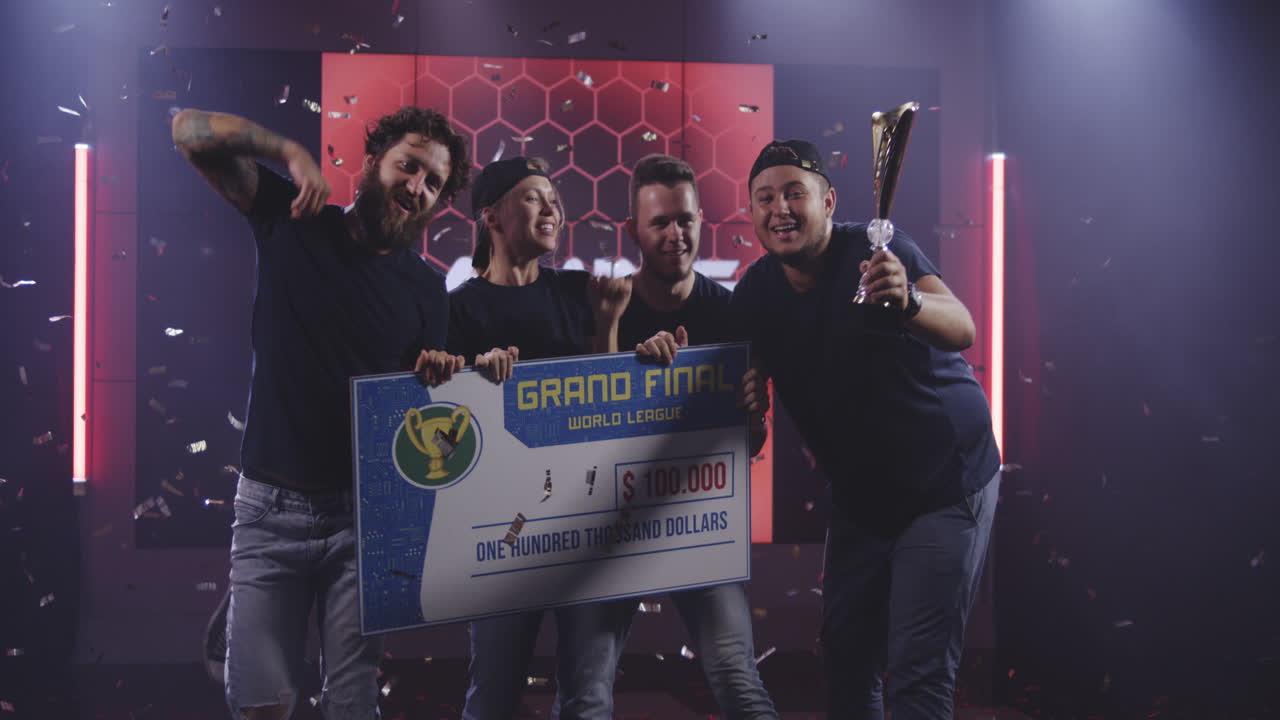 Gaming Tournament Team Celebrating their Victory Medium Shot of a Gaming Tournament Team Holding their Prize while Celebrating their Victory