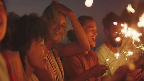 friends playing with fire on the beach