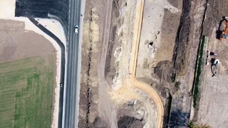 AERIAL---Railroad-construction-and-highway-in-Baden,-Austria,-wide-shot-top-down