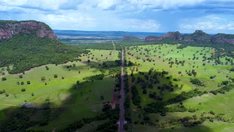 aerial view of the brazilian cerrado , a big mountain, blue sky and a highway - pantanal, brazil