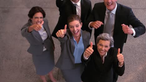 Happy-business-team-showing-thumbs-up