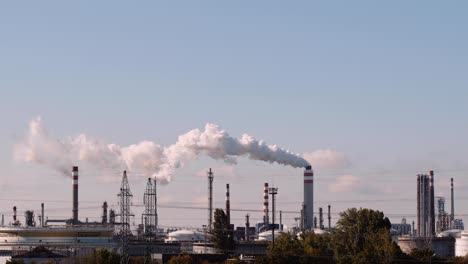 White-smoke-billowing-from-large-factory-chimney---concept-of-industrialisation