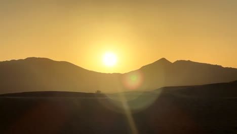 timelapse sun rising over mountain peaks in sahara desert in morocco