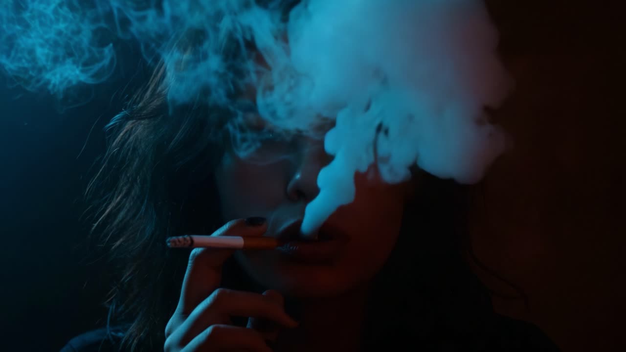 A Captivating Portrait of Mystery: Contrast and Intrigue Capture a Smoky Moment of Reflection and Enigma in Artistic Visuals