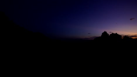 a wide angle shot up in the mountains of the northern part of thailand just before the sun sets. a chilly night begins