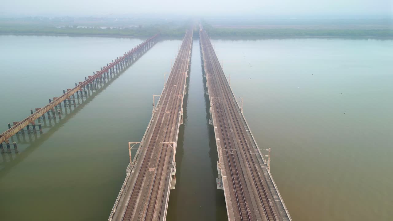 train going from bhayandar staton on vasai creek bridge wide bird eye view