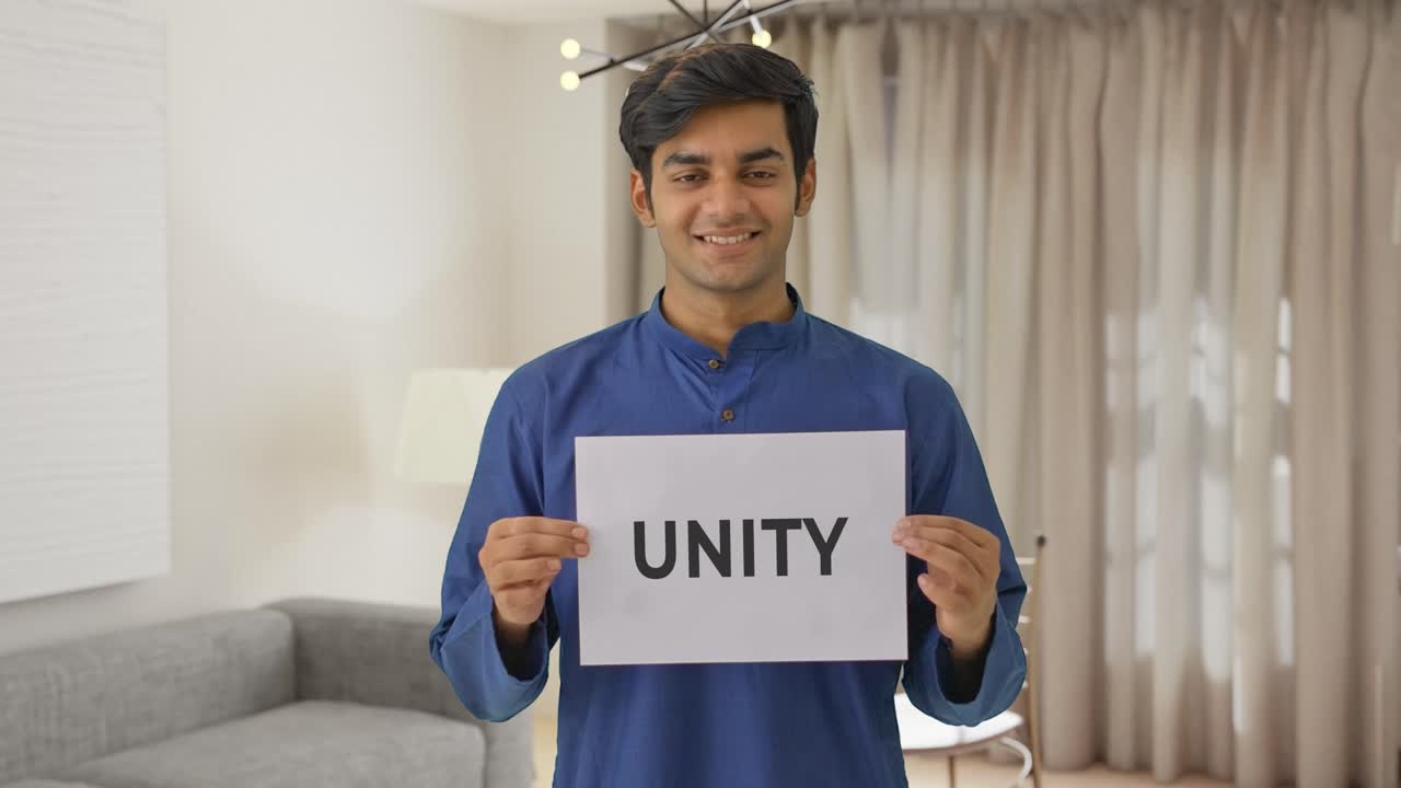 Happy Indian boy holding UNITY banner