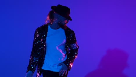 dynamic performance by a man in a sequin jacket and fedora