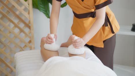 thai leg massage with herbal compresses