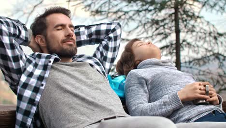 Dad-and-his-teenage-son-with-closed-eyes-relaxing-outdoors/Bielsko-Biala/Poland