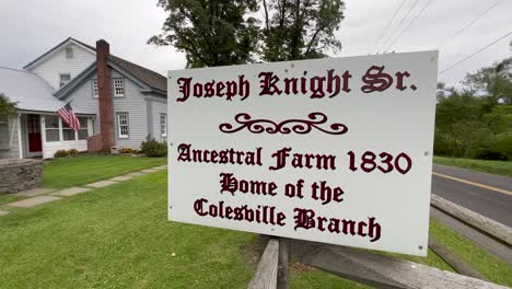 slow-push-on-the-sign-in-front-of-Home-of-the-Knights,-Joseph-Sr-and-Newel-Knight-and-the-place-of-the-first-branch-of-the-church-of-Christ,-Mormons-located-in-Colesville,-New-York-near-Bainbridge