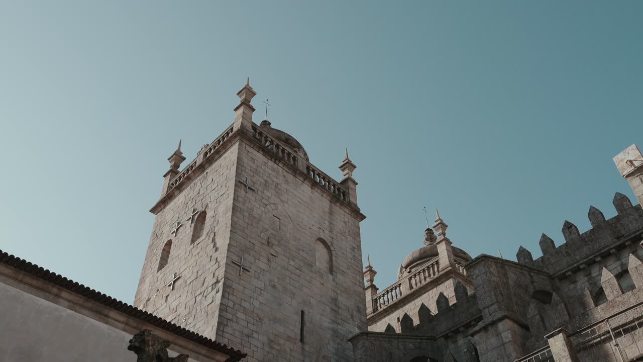 Low angle view of medieval stone tower and ornate architecture inside historic palace in Porto Portugal
